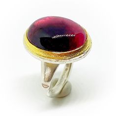 "Extraordinary Sterling silver and 18K Gold ring (bezel) with a beautiful 18,4 mm x 13,6 mm (12,05 carats) oval bicolour Tourmaline cabochon. High quality handmade 18K Gold and Sterling silver ring. Ring size: 6 1/2, DE: 53 (16,8 mm). ESP: 13, UK: N, FR: 53, IT: 13. If it's not the required size, maybe we can adapt to. Please ask for. Also we can make an order custom ring for you. Delivery time a week plus shipment. If you need more information about the dimensions or more images to improve the Modern Oval Dome Ring As Gift, Modern Oval Dome Ring For Gift, Modern Silver Ruby Ring With Oval Shape, Oval Hallmarked Dome Ring As Gift, Oval Hallmarked Dome Ring Gift, Oval Cabochon Dome Ring With Polished Finish As Gift, Gift Dome Ring With Oval Cabochon And Polished Finish, Handmade Oval Ruby Ring For Formal Occasions, Oval Dome Ring With Bezel Setting As Gift