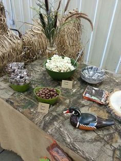 a table topped with bowls filled with different types of food and marshmallows