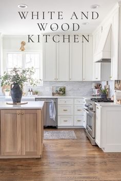 a white and wood kitchen with wooden flooring in the center, an island countertop and cabinets