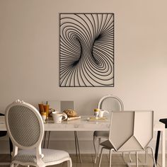 a dining room table with chairs and a painting on the wall above it that has an abstract swirl design