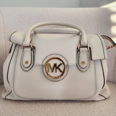 *Brand New & Never Worn* - Original Tags W/ Dustbag Included. White Michael Kors Satchel Bag In The Color "Vanilla". Leather Material With Gold Hardware. Very Spacious With Multiple Pockets And Compartments And A Long Strap To Be Worn As A Cross Body. Dimensions: L - 12" H - 8" W - 6.5" Michael Kors Cream Shoulder Bag With Detachable Handle, Michael Kors Cream Bag With Detachable Handle, Cream Satchel With Gold-tone Hardware For Errands, Cream Shoulder Bag With Branded Hardware And Double Handle, Cream Shoulder Bag With Branded Hardware, Michael Kors Cream Bag With Adjustable Strap, Michael Kors Beige Satchel With Detachable Handle, Michael Kors Cream Top Handle Shoulder Bag, Michael Kors Cream Satchel Shoulder Bag