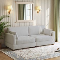 a living room scene with focus on the couch and rug in front of the mirror