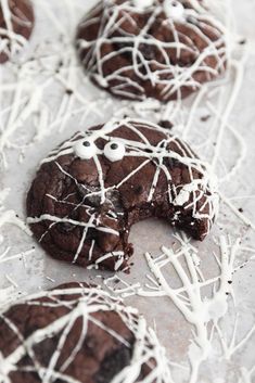 chocolate cookies decorated with white icing and eyes