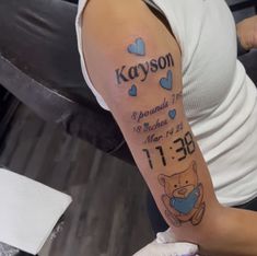 a woman with a tattoo on her arm that reads kayson and has hearts around it