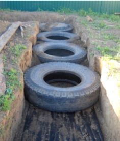 four tires are lined up in the back of a truck