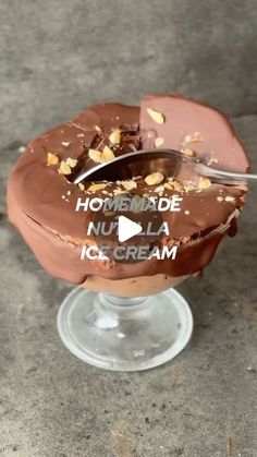 an ice cream sundae with chocolate frosting and nuts