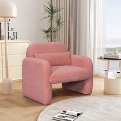 a living room with a pink chair in the middle and a white rug on the floor