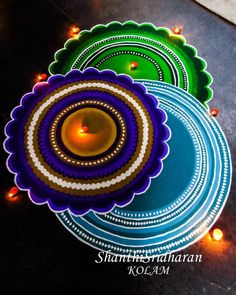 three colorful plates with candles on them