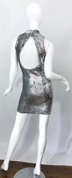 For Sale on 1stDibs - Chic 1960s HATTIE CARNEGIE silver fully sequined vintage open back mini dress! Features thousands of hand-sewn silver sequins throughout on a soft stretch Silver Sequin Dress With Contrast Details, Silver Backless Sequin Dress For Summer, Metallic Fitted Sequin Mini Dress, Fitted Metallic Mini Dress With Sequins, Silver Sequined Mini Dress For Disco, Silver Sequined Disco Mini Dress, Silver Sequin Disco Mini Dress, Silver Backless Sequin Dress For Party Season, Fitted Silver Sequin Dress With Contrast Sequins