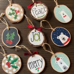 christmas ornaments are hanging on wood slices with the words peace, joy, joy and polar bear