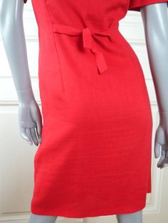 This red summer dress has a square neckline and closes in the front with eight red pearlescent buttons. The above-the-knee short-sleeve dress has figure-enhancing contour lines on the front of the bodice, padded shoulders, and two patch pockets at hip level. The back features a tie-back belt. The high-quality linen-blend dress is fully lined in red 100% acetate fabric. Condition: Near Mint (Like New ... Professionally Cleaned ... soft and supple, with no stains, tears, wear spots, or weaknesses Classic Lined Mini Dress For Summer, Solid Color Vintage Summer Dress, Vintage Sheath Dress For Summer, Red Vintage Knee-length Mini Dress, Classic Summer Dress With Straight Neckline, Vintage Summer Mini Dress For Formal Occasions, Red Fitted Mini Dress For Daywear, Fitted Red Mini Dress For Daywear, Red Sheath Dress For Summer