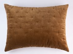 a brown pillow on a white background