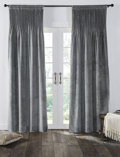 the curtains in this room are gray and have tasselled fringes on them