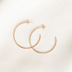 Classic and adorable - we think everybody needs these hoops. These are the kind of hoops you put in and never take out, and you don't need to! You can wear them to the office, at the gym, in the shower, and even to bed. DETAILS 14k gold filled -or- sterling silver hoops with butterfly studs 1.2mm width Available in 3 sizes: small (12mm), medium (20mm), & large (38mm) Comes as a pair Types Of Gold, Open Hoop Earrings, Large Hoop Earrings, At The Gym, Favorite Rings, Sterling Silver Hoops, Dainty Jewelry, Gold Filled Jewelry, Silver Hoops