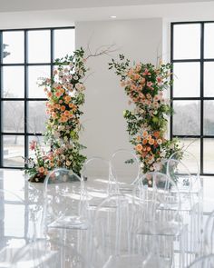 the chairs are lined up with flowers on them