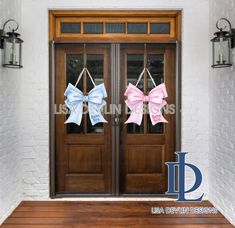 two bows on the front door of a house