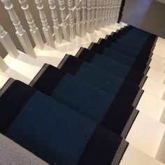 the stairs are lined with black and white carpet