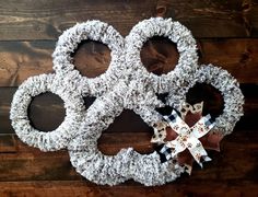 three wreaths made out of yarn on top of a wooden floor