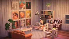 a living room filled with furniture and pictures on the wall