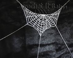 a spider web is shown on a black background with the word, crochet it bat