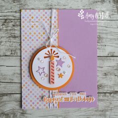 a handmade birthday card with a candle and stars on the front, hanging from a string