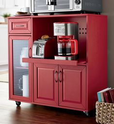 a red cabinet with a microwave and coffee maker on top