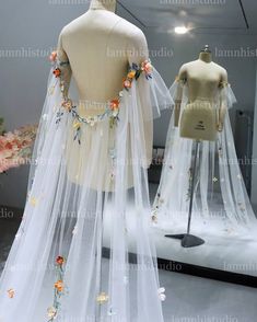 two mannequins with veils and flowers on them