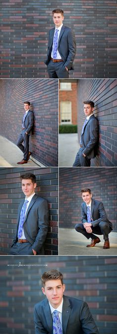 a man in a suit leaning against a brick wall