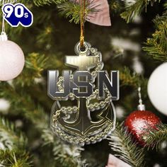 an ornament hanging from a christmas tree with the usn logo on it