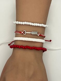 Cupid Arrow Bow Charm Friendship Bracelet. Pura Vida style string, braided, woven, beaded, adjustable bracelet.  Fits most wrists and are stackable.  Perfect for everyday casual wear, activities, and special events. Can be worn individually or as a set. SIZING: White Braided Bracelet:  6 - 11 inches Beaded Red/White Bracelet:  2.36 inches CARE: Bracelets are durable, but excess pulling or yanking may cause them to break. SPECIAL NOTES: Your new bracelet may be slightly sticky/tacky for a few days.  This will not last, but may make adjusting slightly difficult for a bit. Cupid Bow, Arrow Bow, Cupid Arrow, Wax Cord Bracelet, Knotted Bracelet, Bracelets Adjustable, Thread Bracelet, Arrow Bracelet, Cupids Arrow