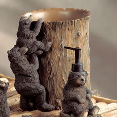 two bears are playing with each other in front of a tree stump that is holding a water faucet