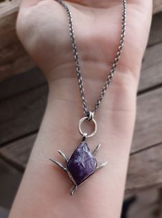 This raw amethyst crystal pendant necklace is hand forged in a 925 sterling silver bezel and a silver chain. It has been oxidized and polished, to give the piece an antique look.  A unique, fantasy piece of jewelry that will add character to any look and is ideal as a gift to yourself or to someone special.  The total length of the chain is 460mm, please contact me if you would like me to custom made the length of your chain. Please contact me if you would like a wax cord or any customization for your necklace. All my pieces are high quality handmade pieces, made by using only organic traditional silversmithing techniques and no chemicals. Thank you for visiting my shop!  ♥ Unique Sterling Silver Necklace With Raw Stone, Mystical Silver Amethyst Crystal Necklace, Silver Amethyst Necklace With Raw Stone, Hand Forged Amethyst Pendant Necklace, Organic Traditional, Mystical Raw Stone Pendant Necklace, Adjustable Hand-wrapped Amethyst Crystal Necklace, Amethyst Pendant Necklace With Raw Stone, Raw Amethyst Necklace