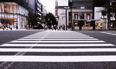 an empty street with people walking on it