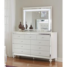 a white dresser and mirror in a room