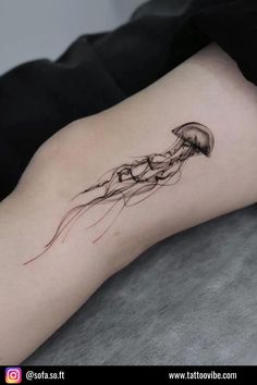 a woman's leg with a tattoo on it that has jellyfishs floating in the water