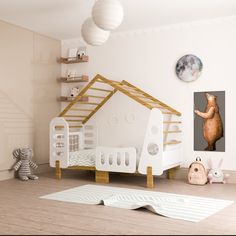 a child's bedroom with a white bed and wooden furniture