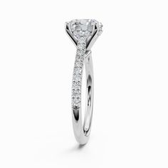 a white gold engagement ring with an oval cut diamond in the center and side stones