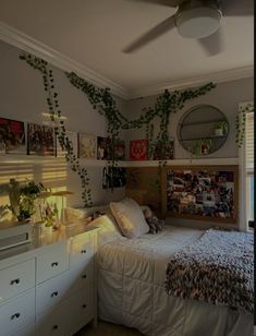 a bedroom with a bed, dresser and window covered in ivys on the wall