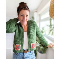 a woman wearing a green crocheted cardigan sweater