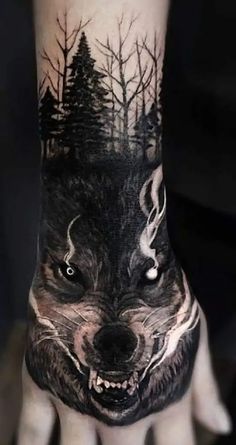 a person with a wolf tattoo on their hand