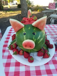 a watermelon shaped like a pig with strawberries on it