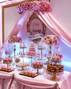 a table topped with lots of cakes and cupcakes