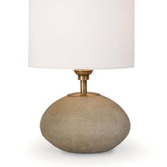 a table lamp with a white shade on it's base and a gold finish