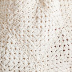 the texture of a crocheted blanket is white