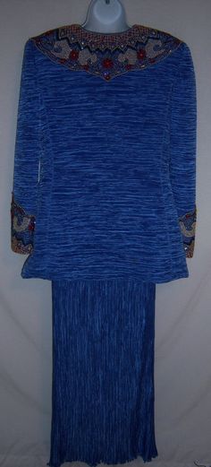 "Vintage Mary McFadden blue, red, ivory and gold heavily beaded pleated liquid Grecian evening jacket with matching skirt. Good pre-owned condition. No holes, stains, snags, rips, tears, fading, etc. Women's size 12 or 14. Measurements: jacket bust-40\", waist-36\" length-31\", skirt waist-32\", hips-60\", length-43\". Side zip closure on skirt. 100% polyester. Button front jacket. From Miss Jackson's." Royal Style Long Sleeve Party Sets, Royal Long Sleeve Party Sets, Blue Long Sleeve Evening Set, Pleated Long Sleeve Sets, Blue Fitted Festive Skirt, Festive Fitted Blue Skirt, Festive Blue Fitted Skirt, Blue Fitted Skirt For Festive Occasions, Blue Sequined Long Sleeve Set