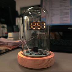 an alarm clock sitting on top of a wooden base