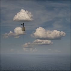 there is a man standing on the top of a tower in the middle of the ocean