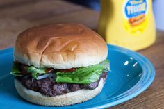 a hamburger sitting on top of a blue plate