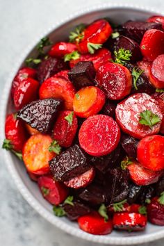 beets and carrots in a white bowl with parsley on the top, ready to be eaten