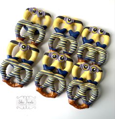 six yellow and blue decorated bananas with eyes on each one, all in the same pattern